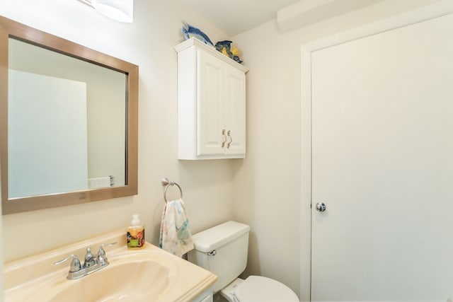 bathroom featuring toilet and vanity