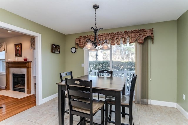 tiled dining space featuring an inviting chandelier