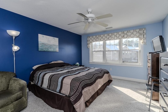 bedroom with ceiling fan and light carpet