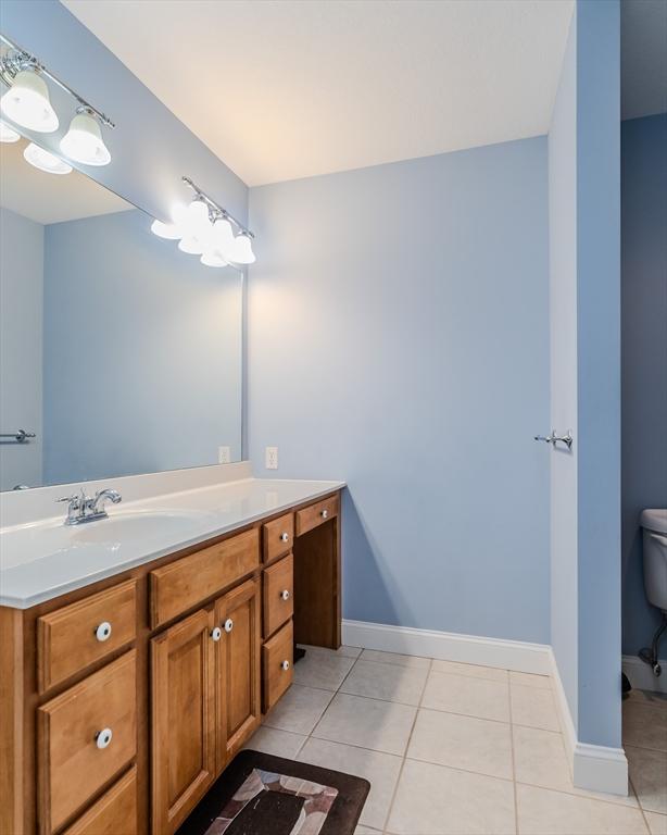 bathroom with tile patterned floors, vanity, and toilet