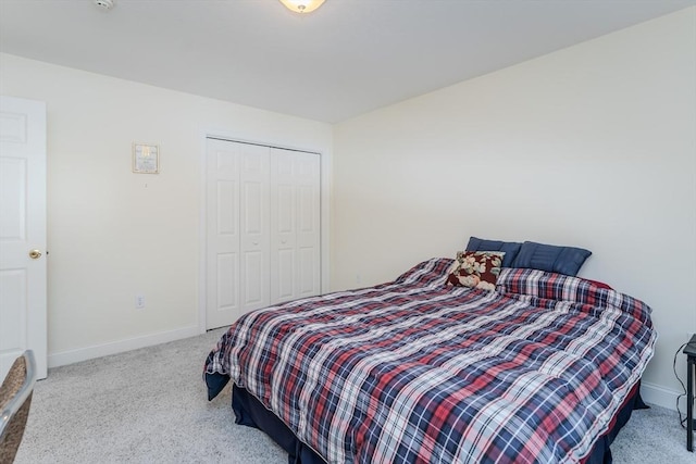 bedroom featuring light carpet and a closet