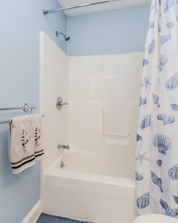 bathroom with shower / tub combo with curtain