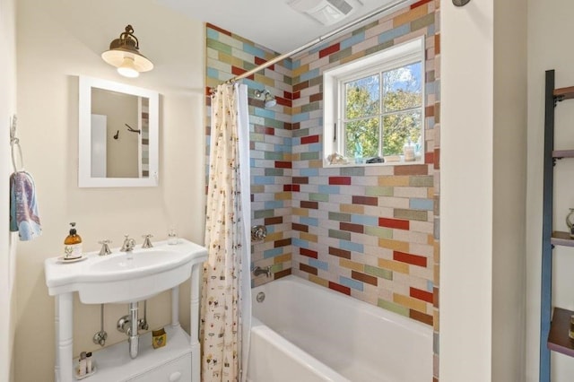 bathroom with sink and shower / bath combo with shower curtain