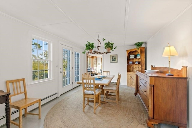 dining room featuring crown molding and baseboard heating