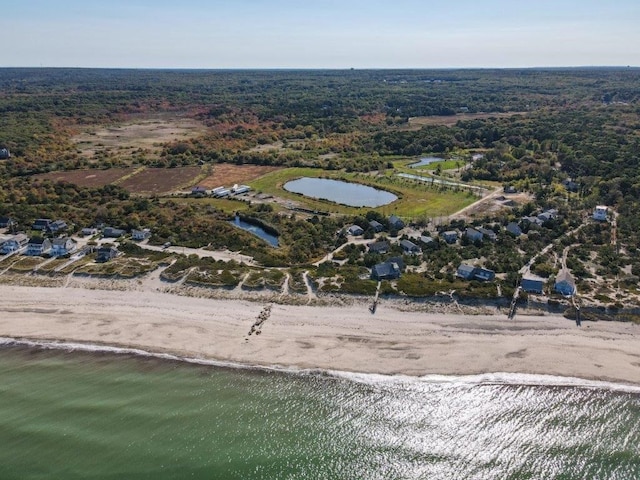 drone / aerial view featuring a water view and a beach view