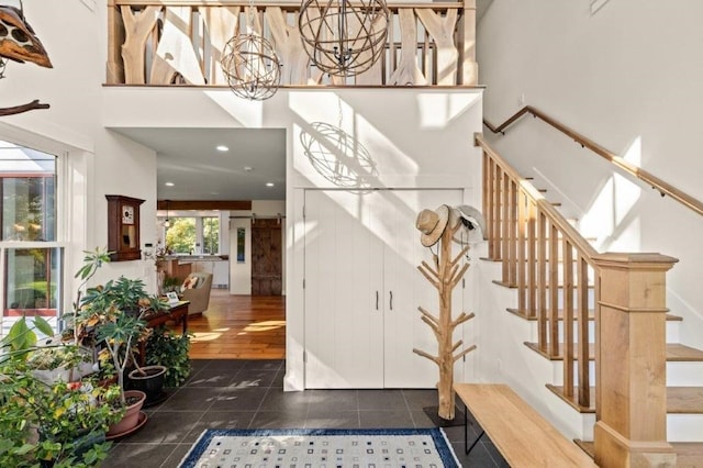 stairway featuring an inviting chandelier and tile patterned flooring