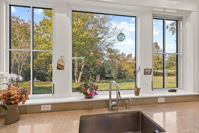 room details with light stone counters and sink