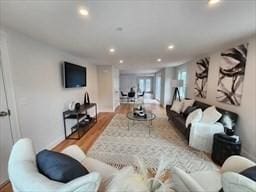 living area with light wood-type flooring and recessed lighting