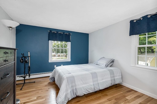 10 Shea Cir, Burlington, MA 01803 - bedroom featuring a baseboard heating unit and wood finished floors