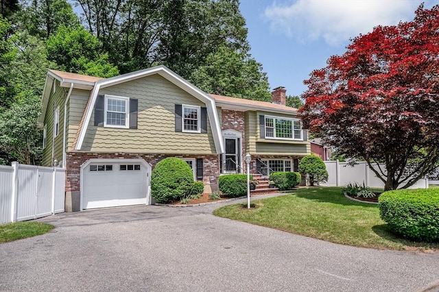 10 Shea Cir, Burlington, MA 01803 - bi-level home featuring an attached garage, driveway, and a chimney