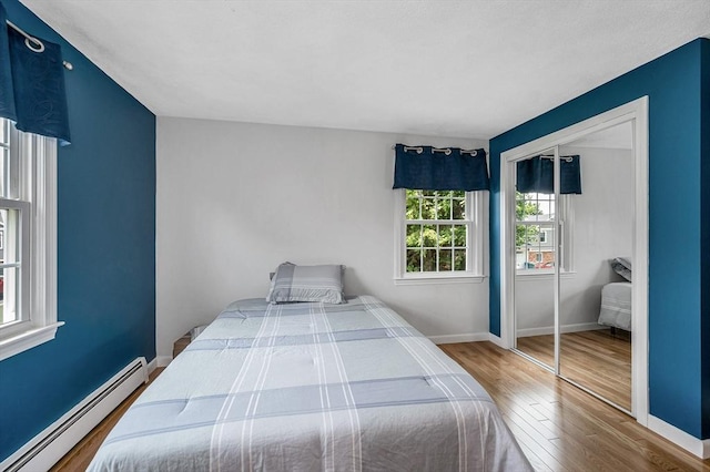 10 Shea Cir, Burlington, MA 01803 - bedroom with a baseboard heating unit, wood finished floors, and a closet