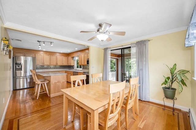 10 Shea Cir, Burlington, MA 01803 - dining area featuring light wood-type flooring, baseboard heating, ceiling fan, and crown molding