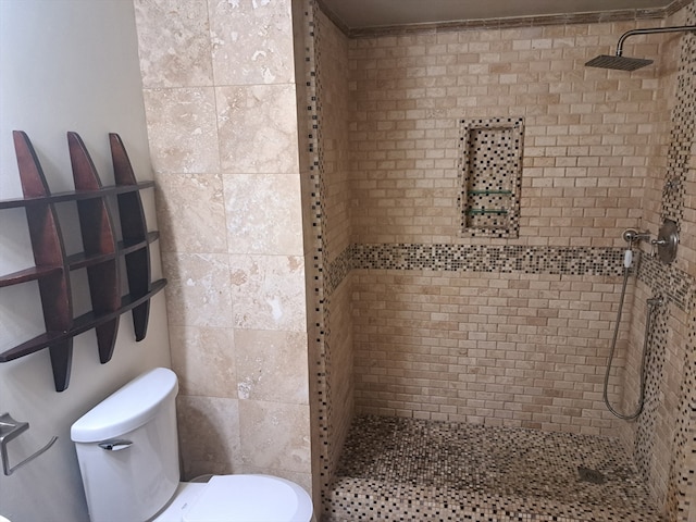 bathroom with tiled shower and toilet