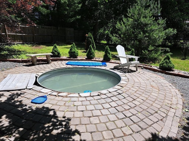 view of swimming pool featuring an in ground hot tub and a patio