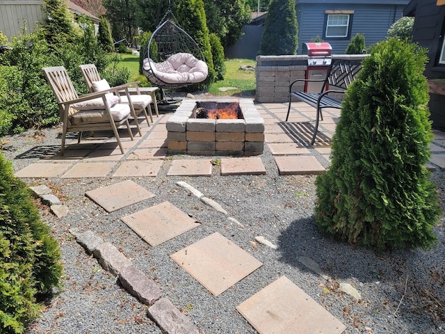 view of patio featuring an outdoor living space with a fire pit