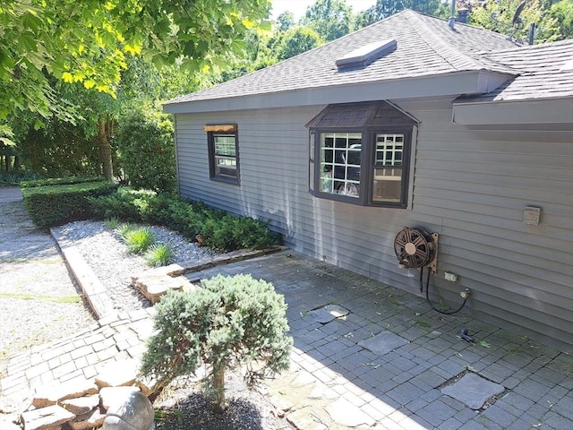 view of side of home featuring a patio area