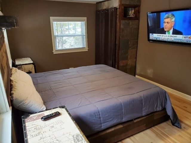 bedroom with hardwood / wood-style floors