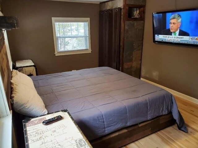 bedroom with hardwood / wood-style flooring