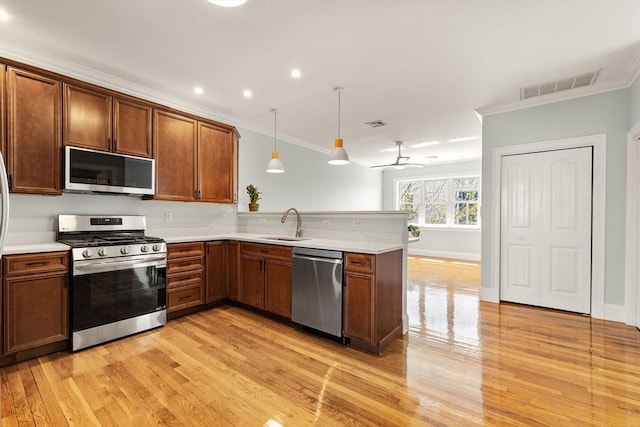 kitchen with crown molding, appliances with stainless steel finishes, visible vents, and light wood-type flooring