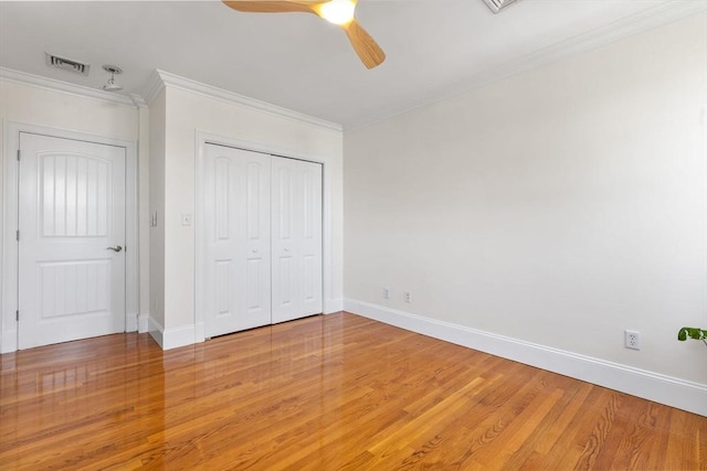 unfurnished bedroom with visible vents, baseboards, and light wood-style floors