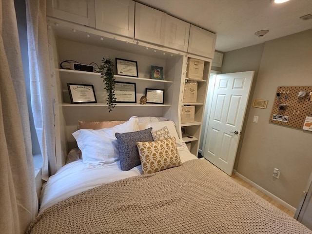 bedroom featuring wood finished floors and baseboards