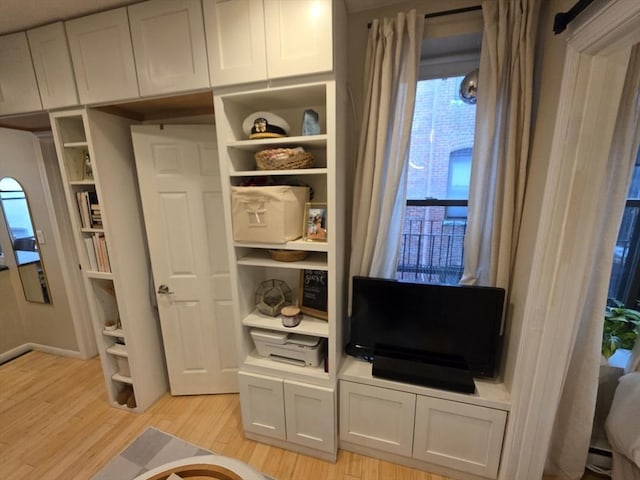 mudroom with light wood-style floors and built in features