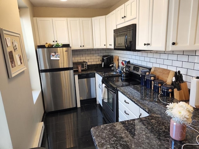 kitchen with appliances with stainless steel finishes, white cabinets, decorative backsplash, and a baseboard radiator