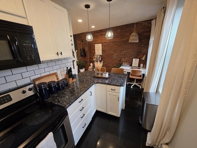 kitchen featuring stainless steel electric stove, white cabinets, brick wall, black microwave, and a peninsula