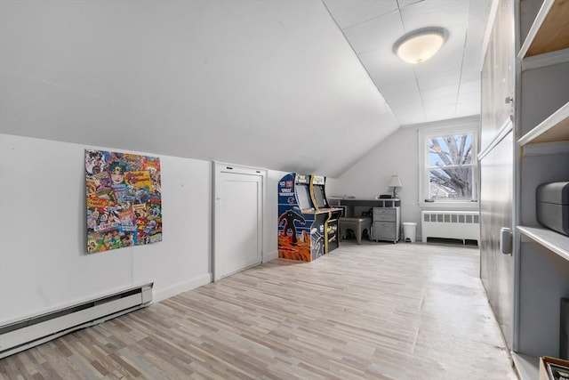 bonus room featuring a baseboard radiator, radiator, lofted ceiling, and wood finished floors