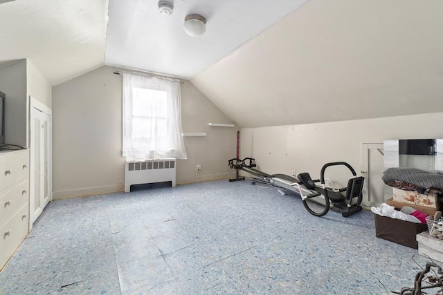 additional living space with baseboards, lofted ceiling, and radiator heating unit