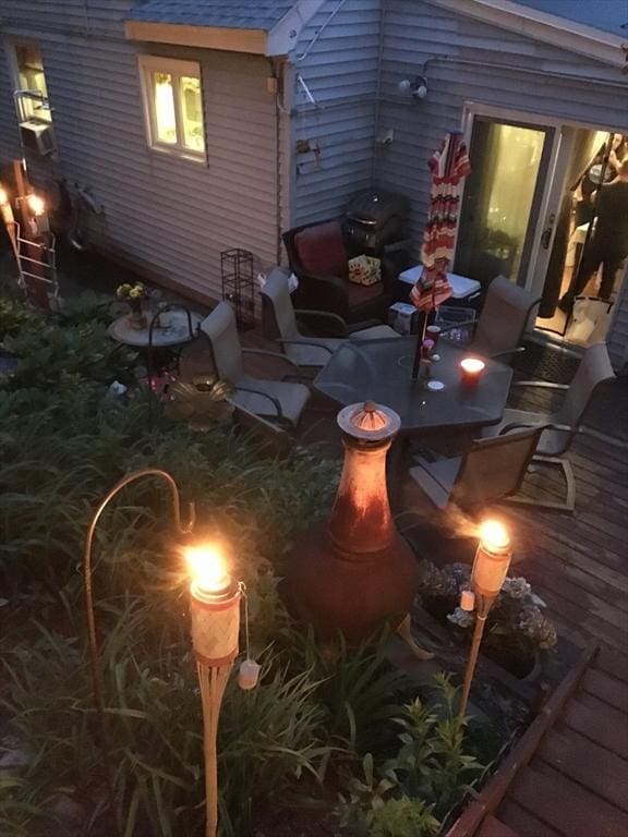 exterior space with an outdoor fire pit and a wooden deck