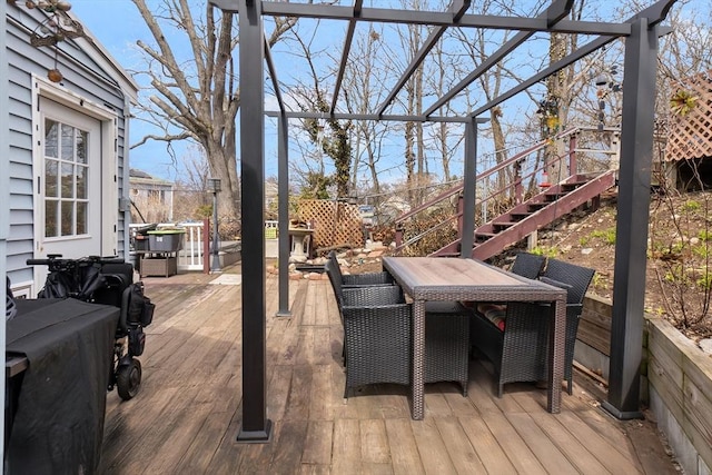 wooden terrace with stairs and outdoor dining area