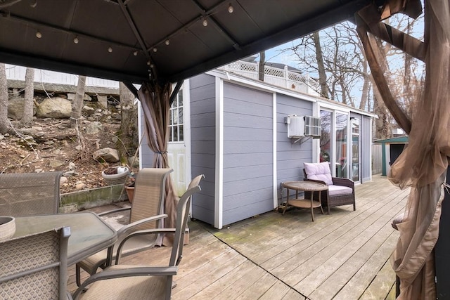 wooden terrace featuring a gazebo