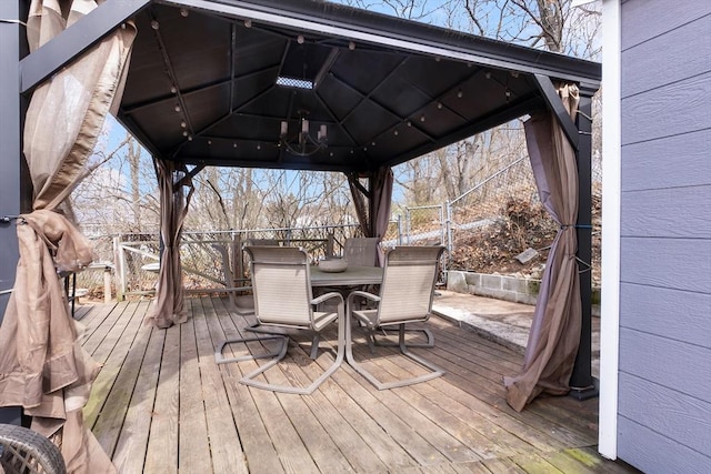 deck with a gazebo and outdoor dining space
