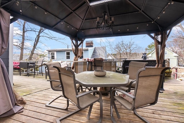 deck with a gazebo and outdoor dining space