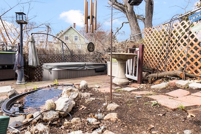 view of yard with a covered hot tub