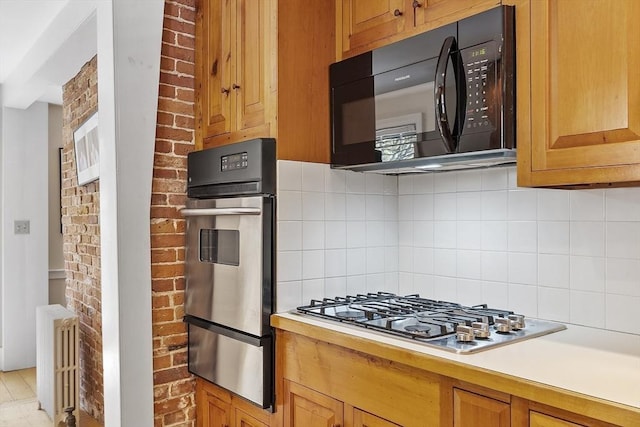20 Andrew St, Salem, MA 01970 - kitchen featuring stainless steel appliances, backsplash, light countertops, and a warming drawer