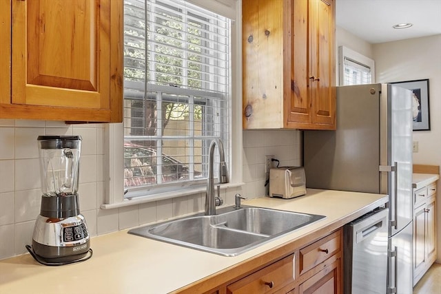 20 Andrew St, Salem, MA 01970 - kitchen featuring stainless steel dishwasher, brown cabinets, light countertops, and a sink