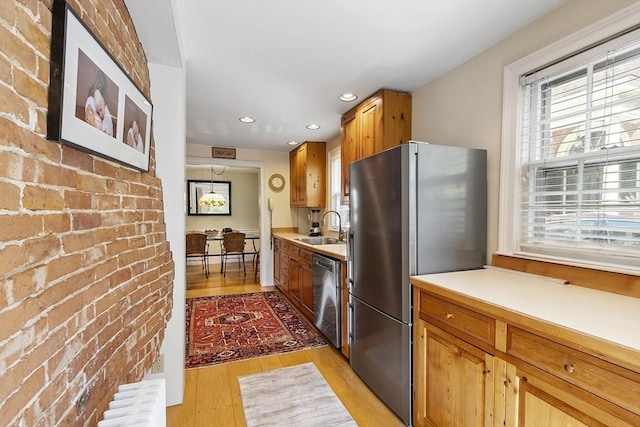 20 Andrew St, Salem, MA 01970 - kitchen with a sink, radiator heating unit, light wood finished floors, light countertops, and appliances with stainless steel finishes