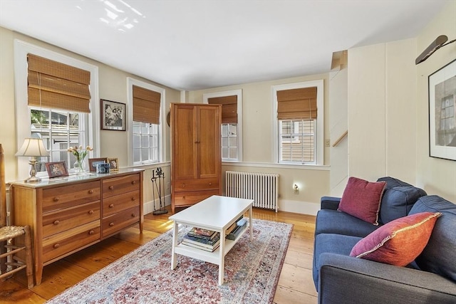 20 Andrew St, Salem, MA 01970 - living area featuring baseboards, light wood-style floors, and radiator heating unit