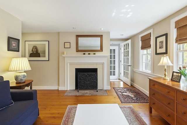 20 Andrew St, Salem, MA 01970 - living area with light wood-style floors, baseboards, a fireplace with flush hearth, and recessed lighting