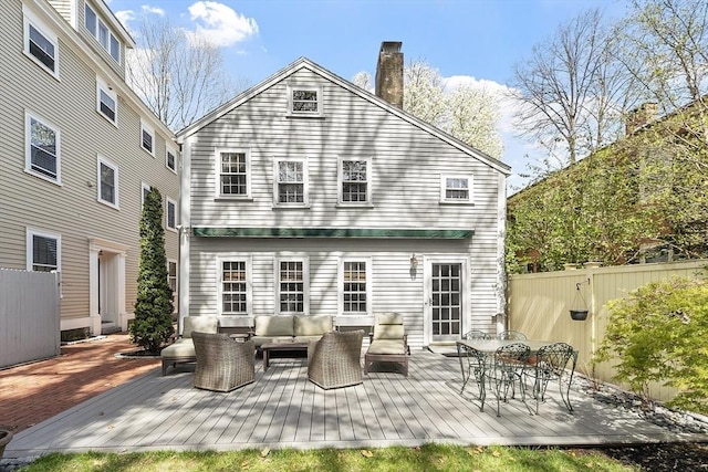 20 Andrew St, Salem, MA 01970 - back of property with fence, a chimney, a deck, and an outdoor living space