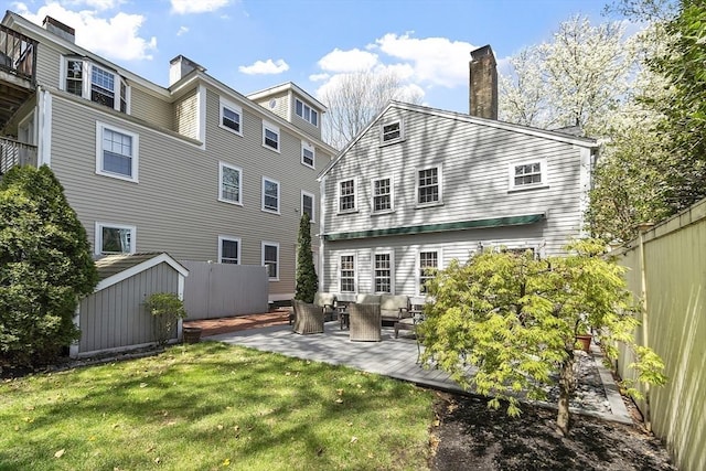 20 Andrew St, Salem, MA 01970 - rear view of property featuring an outdoor living space, a lawn, a patio, a shed, and an outdoor structure