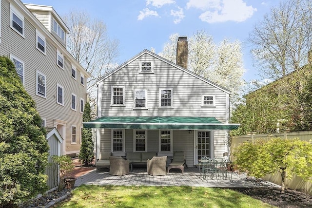 20 Andrew St, Salem, MA 01970 - back of house with an outdoor hangout area, a chimney, a patio, and fence