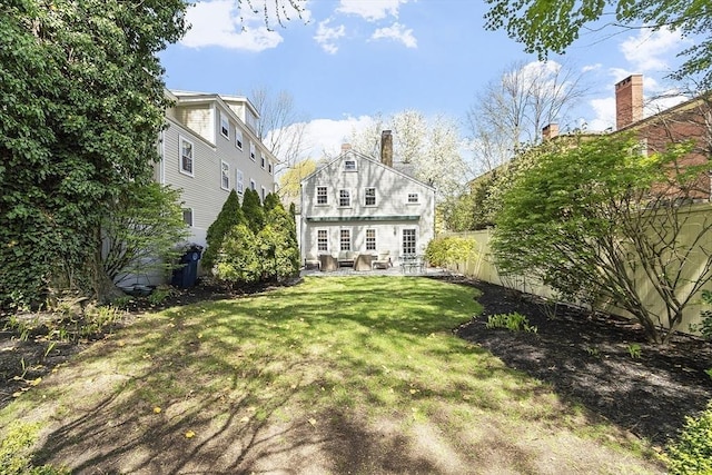 20 Andrew St, Salem, MA 01970 - rear view of property with a chimney, a patio area, fence, and a lawn