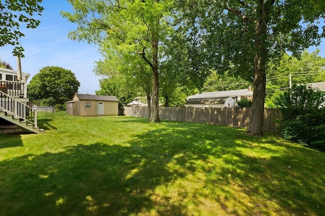 42 Mary Anne Ave, Brockton, MA 02302 - fenced backyard featuring stairs, a storage unit, and a deck
