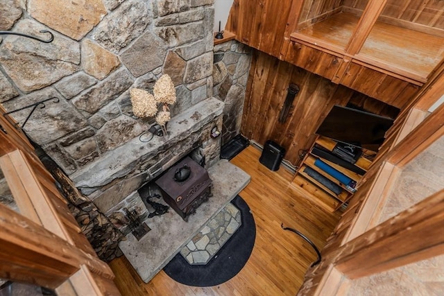 living room with wood-type flooring and a wood stove