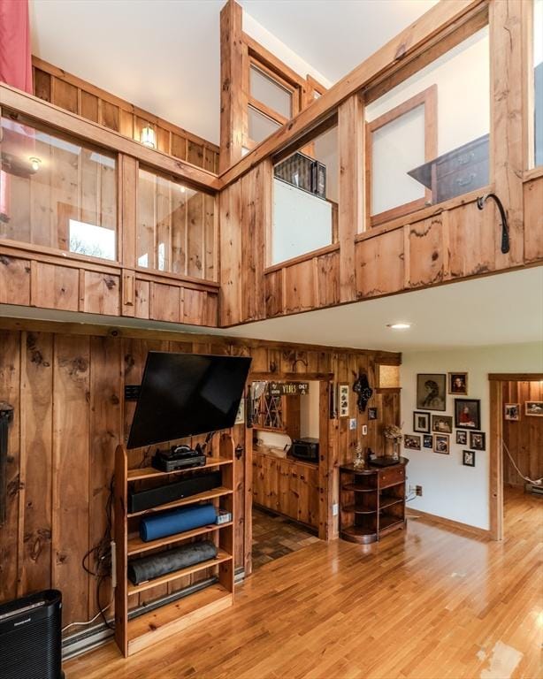 living room with wood-type flooring and wooden walls