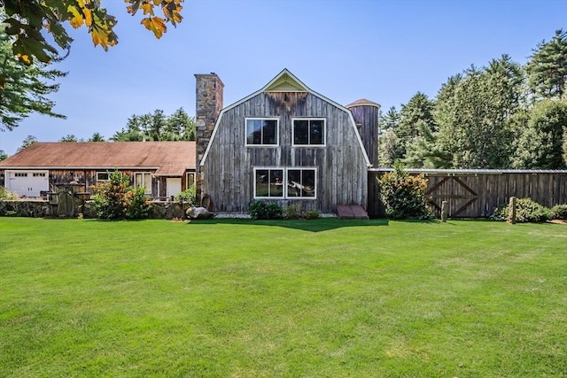 back of house with a lawn