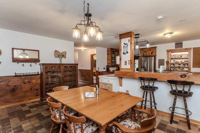 dining space featuring dark parquet flooring and wood walls